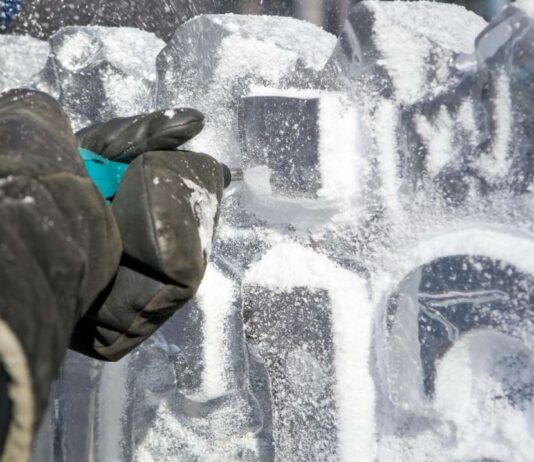 Ice carving in progress at Shiver on the River Detroit during a free winter eco fair with family activities on Belle Isle