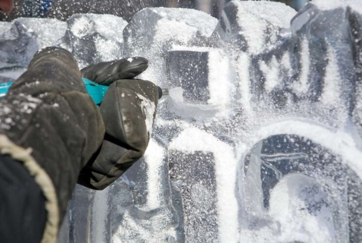 Ice carving in progress at Shiver on the River Detroit during a free winter eco fair with family activities on Belle Isle