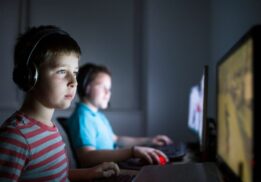 Kids play video games during Video Game Night at The Robot Garage, a supervised evening with kid friendly games and pizza included