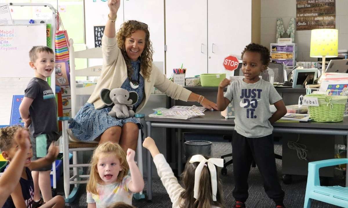 Kindergarten teacher leads an interactive classroom activity with students at Walled Lake Consolidated School District.