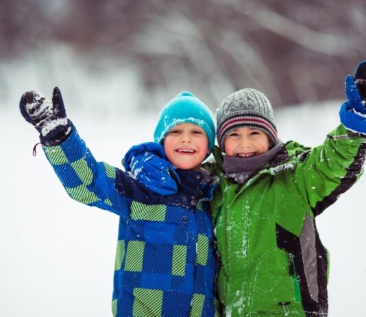 Children enjoy winter orienteering during a family outdoor program, exploring snowy trails and learning navigation skills together