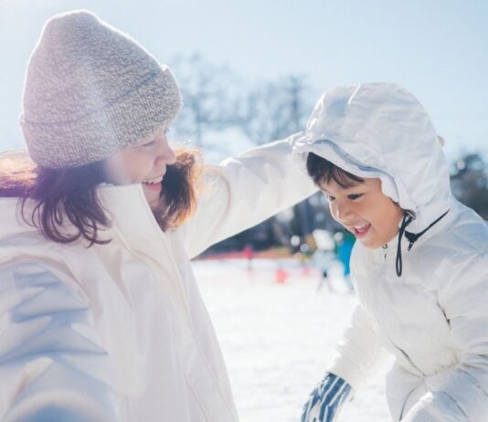 Winter Wonderland at Revel Run Foxhole Biergarten Children enjoy winter activities at Winter Wonderland at Revel Run, playing in the snow during a family friendly winter event outdoors