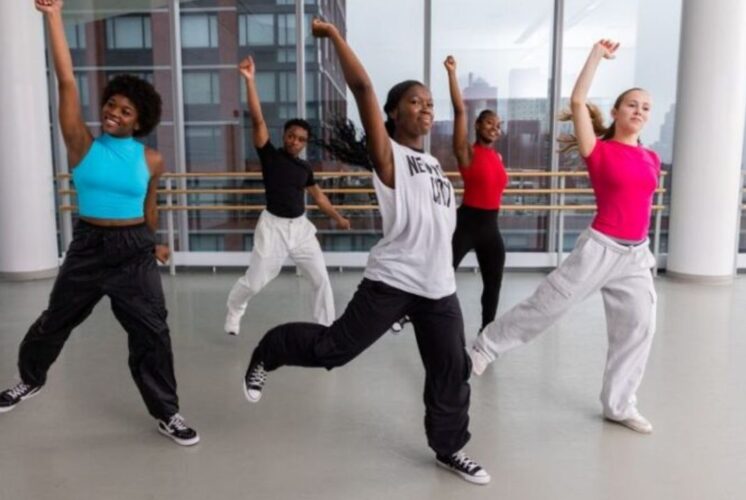 Students participate in Ailey Experience Detroit hip hop dance class learning signature Alvin Ailey style techniques