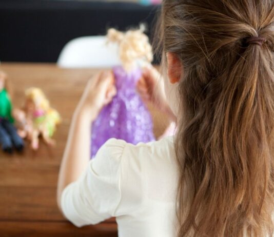 American Girl Tea Party at Saline Recreation with child holding doll in fairy dress ready for crafts and tea party fun