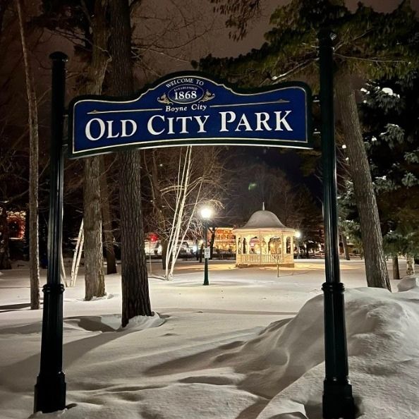 Old City Park in Boyne City, Michigan at night with snow covered trees and gazebo during a winter family getaway near Boyne Mountain.