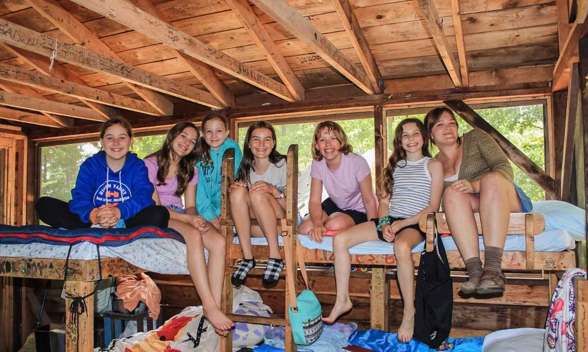 Campers sit on bunk beds inside a cabin during Camp Carvela overnight summer camp in northern Michigan