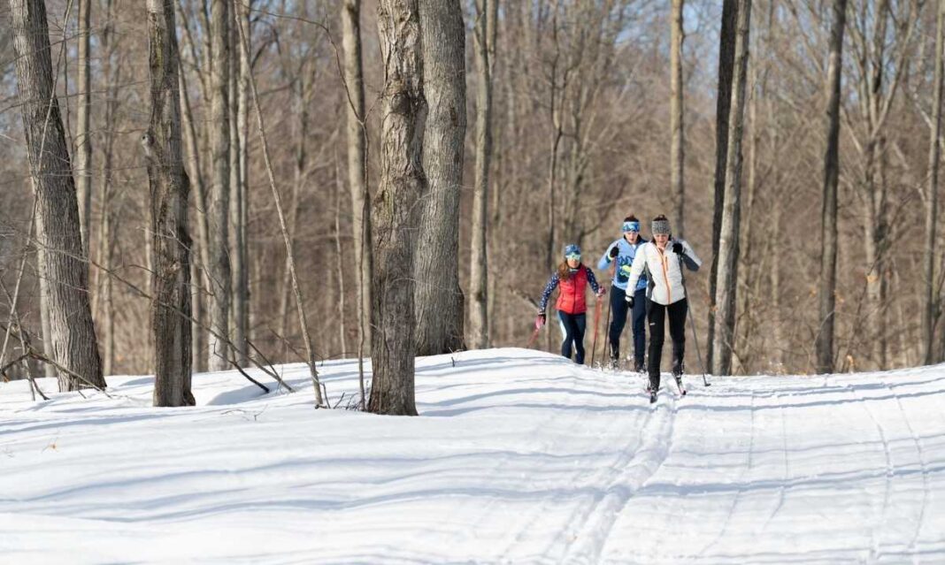 Family cross-country skiing at Crystal Mountain in Thompsonville, Michigan during a winter getaway near Metro Detroit.