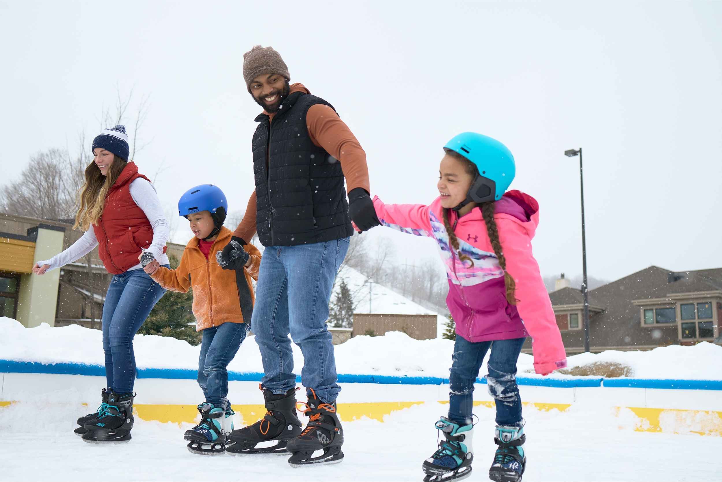 Family ice skating at Crystal Mountain in Thompsonville, Michigan during a winter getaway near Metro Detroit.