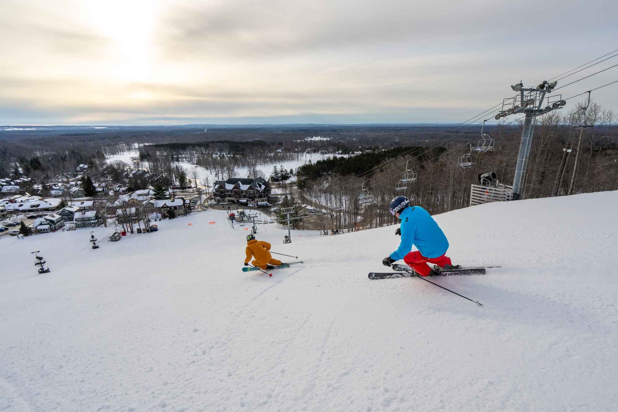 Skiers carve down Crystal Mountain during a Northern Michigan winter road trip near Thompsonville.