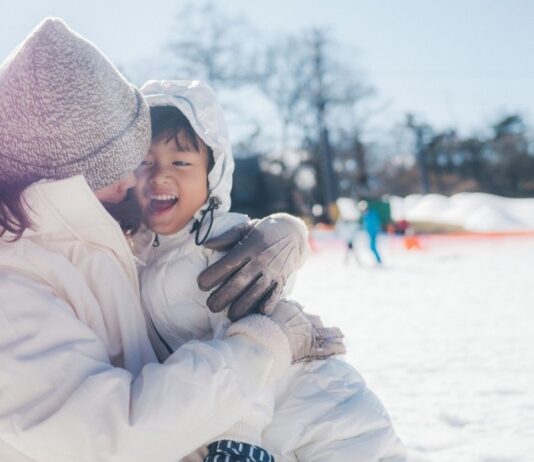 Family enjoying Fireworks and Flannels Cozy Night Out with winter fun in the snow before the evening fireworks display