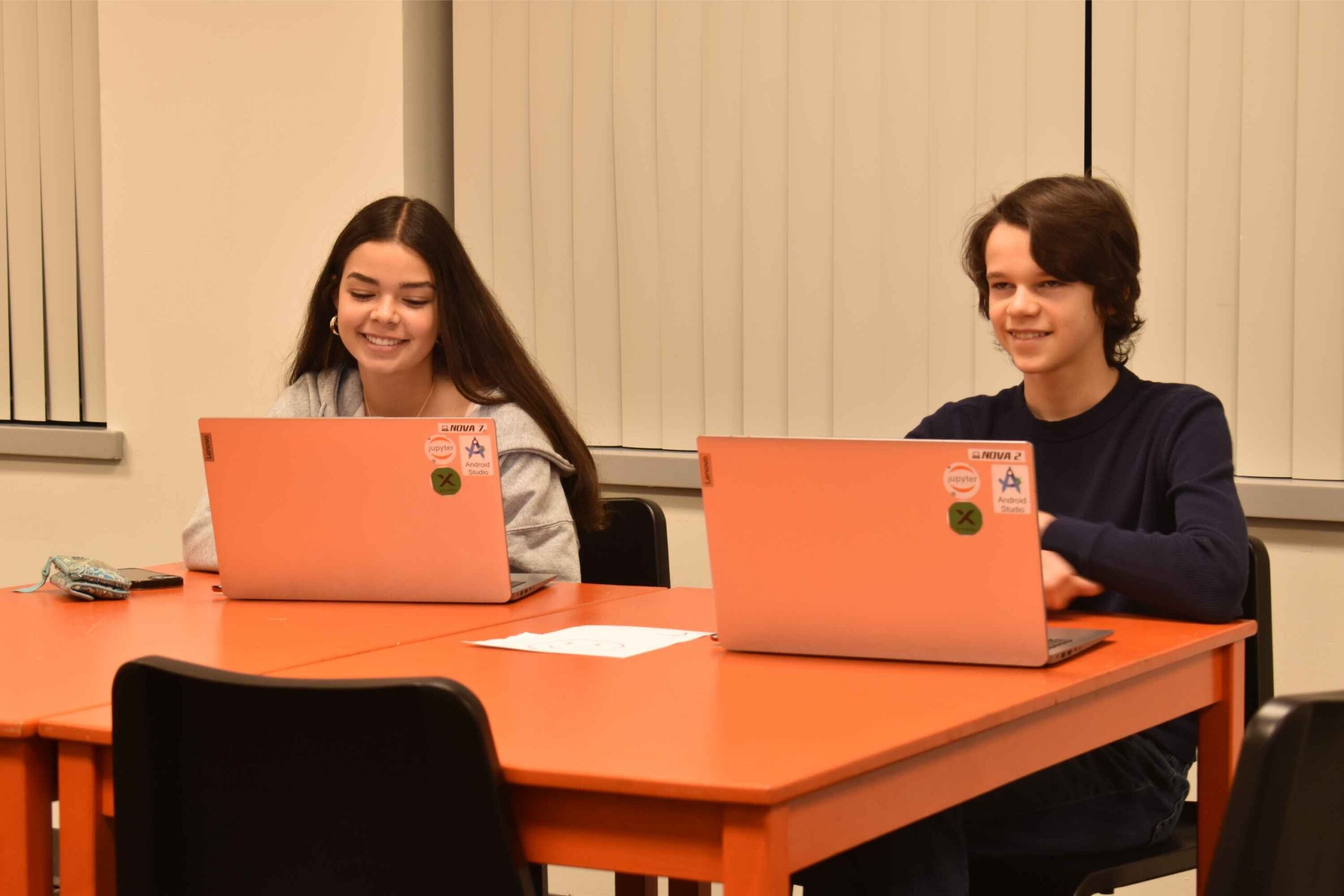 Teens work on laptops during a hands-on STEM camp at The Future Innovators Academy, building coding and problem-solving skills in Ann Arbor.