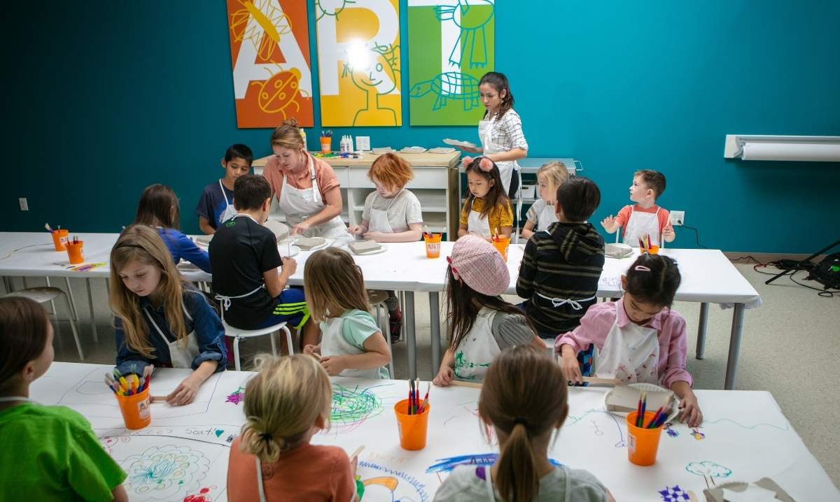 Kids draw and create art projects during a Kidcreate Studio summer camp class in Wixom, Michigan.