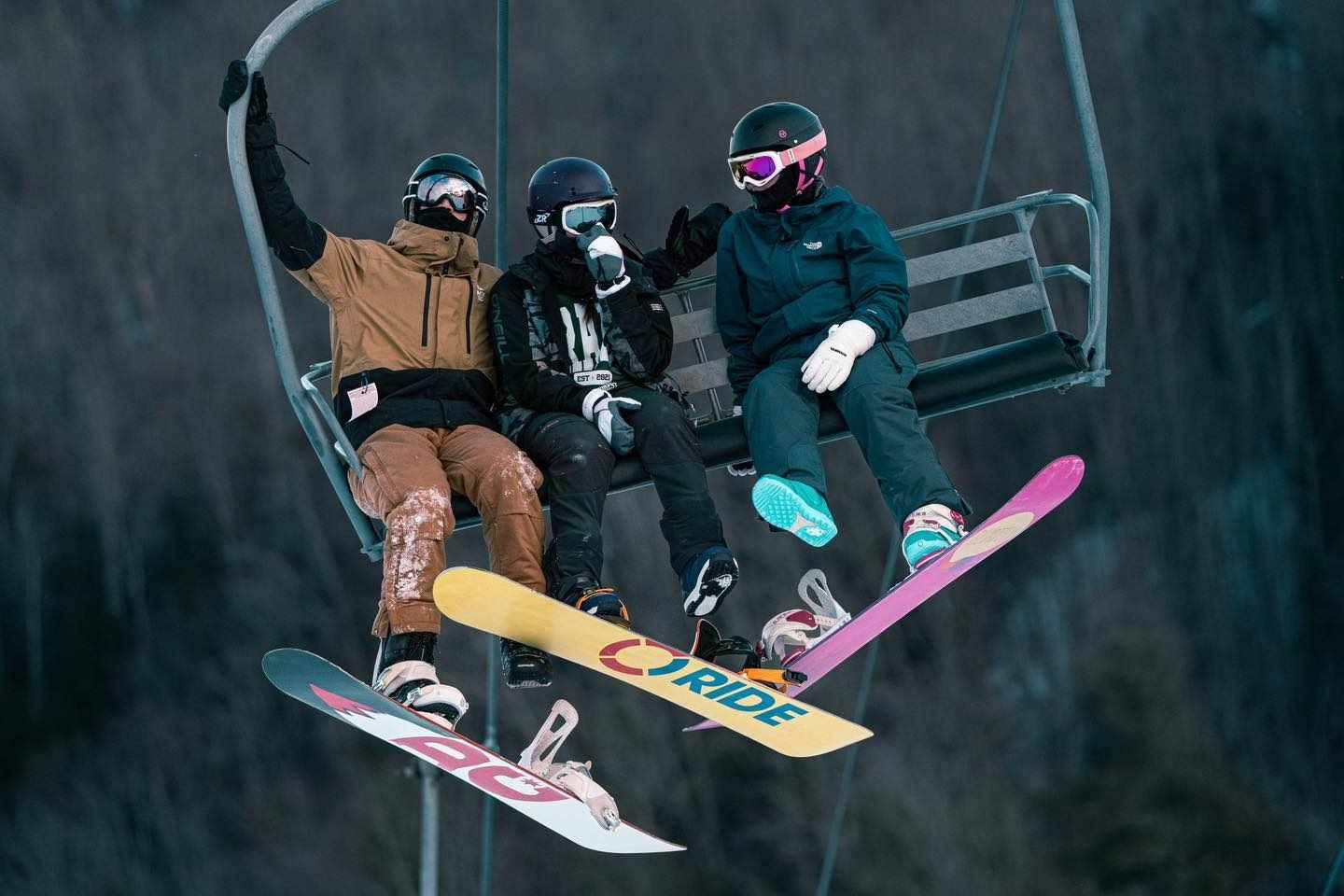 Snowboarders ride a chairlift at Otsego Resort in Gaylord during a Northern Michigan winter road trip.