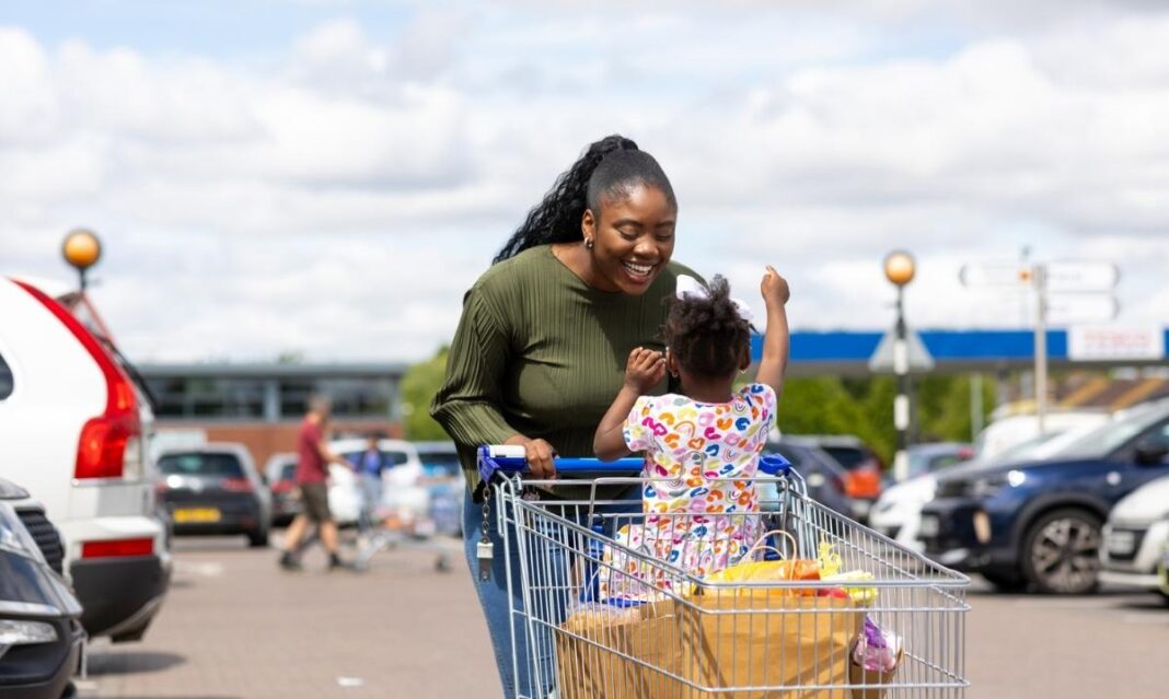 Parent and young child enjoying a grocery store outing, representing everyday community experiences for families of children with autism.