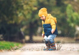 Preschool child splashing in a puddle during Puddle jumpers at Wint Nature Center, a hands on nature program with stories and crafts for young kids.