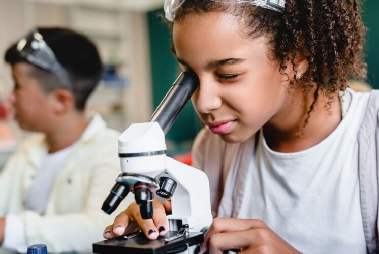 Science Saturdays at Briarwood Mall with kids exploring hands on STEM activities and using a microscope during themed science fun
