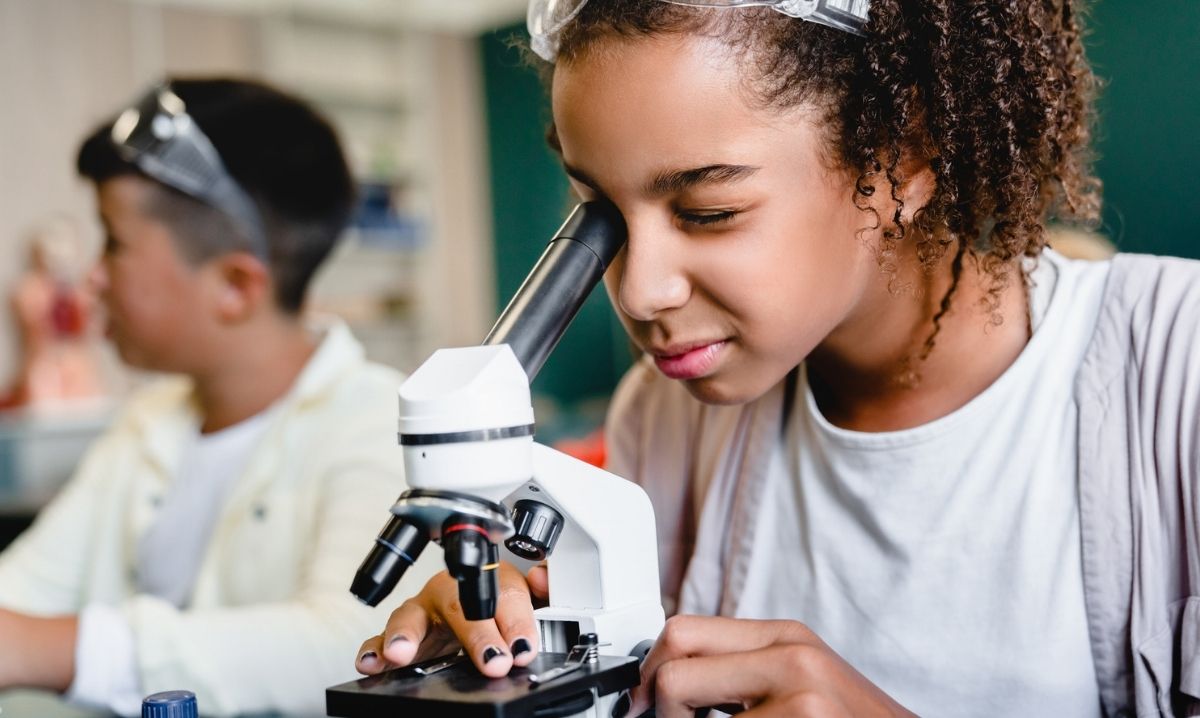 Science Saturdays at Briarwood Mall with kids exploring hands on STEM activities and using a microscope during themed science fun