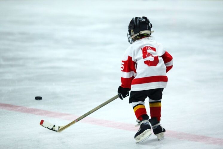 Young sled hockey player on the ice during Showdown in Hockeytown sled hockey at Taylor Sportsplex, a free family friendly adaptive sports event.
