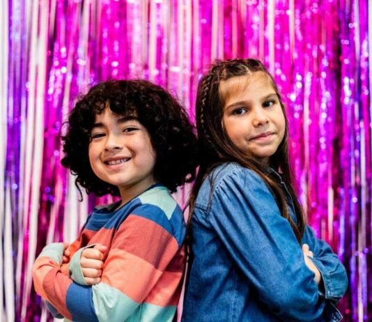 Children posing during Valentines Day sensory party at Novi Library, a playful event with themed activities designed for young kids and caregivers.