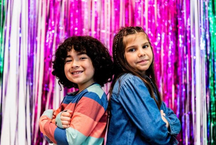 Children posing during Valentines Day sensory party at Novi Library, a playful event with themed activities designed for young kids and caregivers.