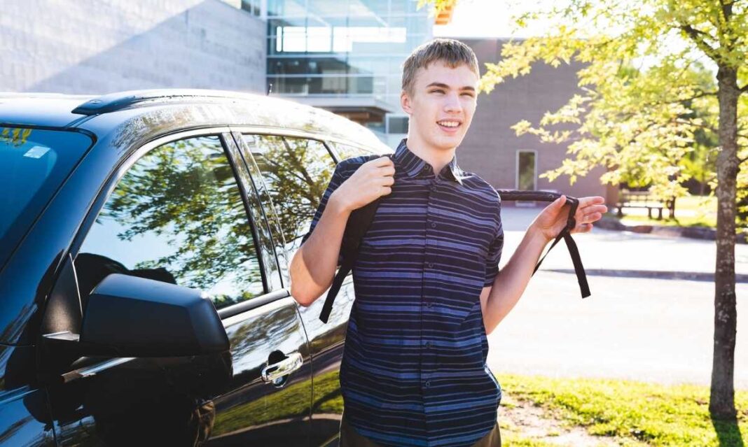 Young adult with autism leaving car with backpack heading to school or work demonstrating independent morning routine.
