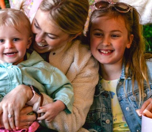 Family with kids enjoying Blake’s Backyard Almont Easter egg hunt event with spring activities bunny fun and family photo moments