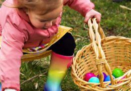 Child collecting colorful eggs during the Blake’s Lyon Twp Easter egg hunt with family friendly spring activities at the orchard