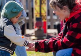 Parent and child collecting eggs at the Blake’s Orchard and Cider Mill Easter egg hunt during a family friendly spring event in Armada