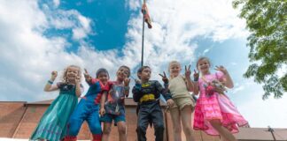 Kids in costumes pose together at Camp Mirage summer camp in metro Detroit, showing themed day camp fun and creativity for ages 5-14