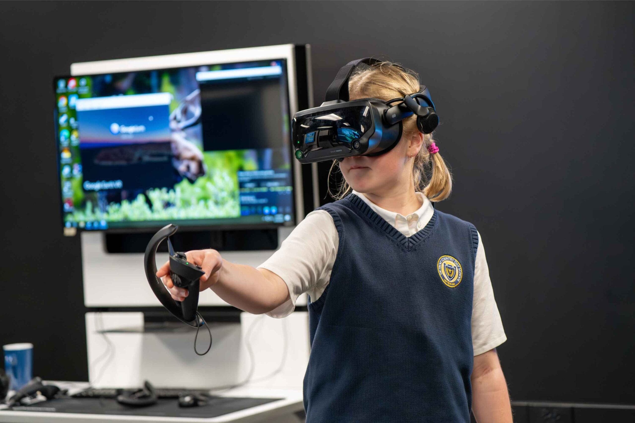 Student uses a virtual reality headset during a STEM camp at Detroit Country Day Camps, exploring immersive tech and hands on learning