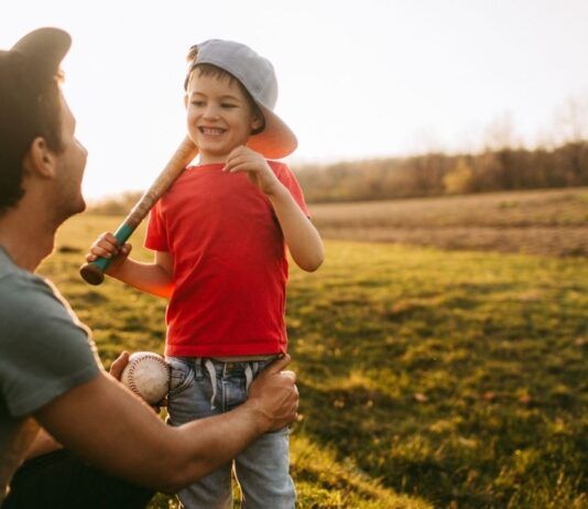 Downtown Detroit Tigers Takeover at Nick Gilbert Way with child holding baseball bat enjoying family friendly baseball fun outdoors