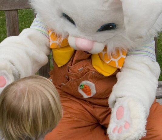 Easter Bunny photos at The Village of Rochester Hills with child meeting Easter Bunny for spring family event and festive fun