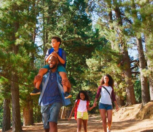 Family hike at Hudson Mills Metropark Family hike at Hudson Mills Metropark with kids and parents walking scenic nature trail and exploring outdoors together