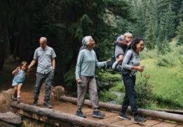 Family nature adventure over and under the pond at Belle Isle Nature Center with families walking on a wooded trail exploring nature together