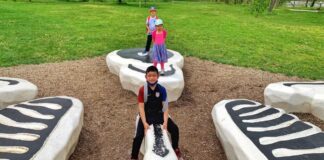Kids play on a playground in Indianapolis during spring break, enjoying outdoor family fun and fresh air on a road trip from metro Detroit
