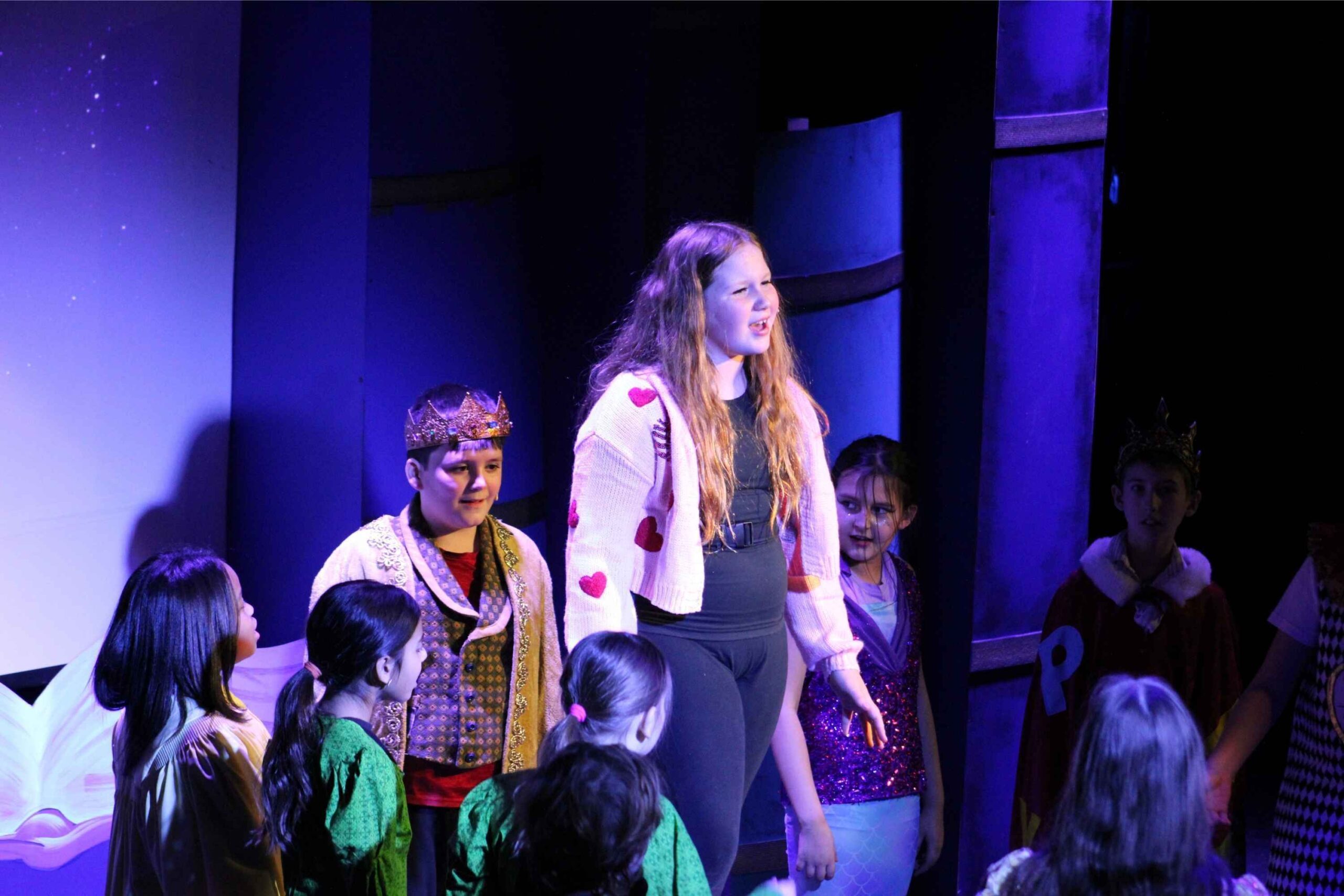 Kids perform in a theater production during spring break in Lansing, enjoying a creative indoor activity for families and young performers