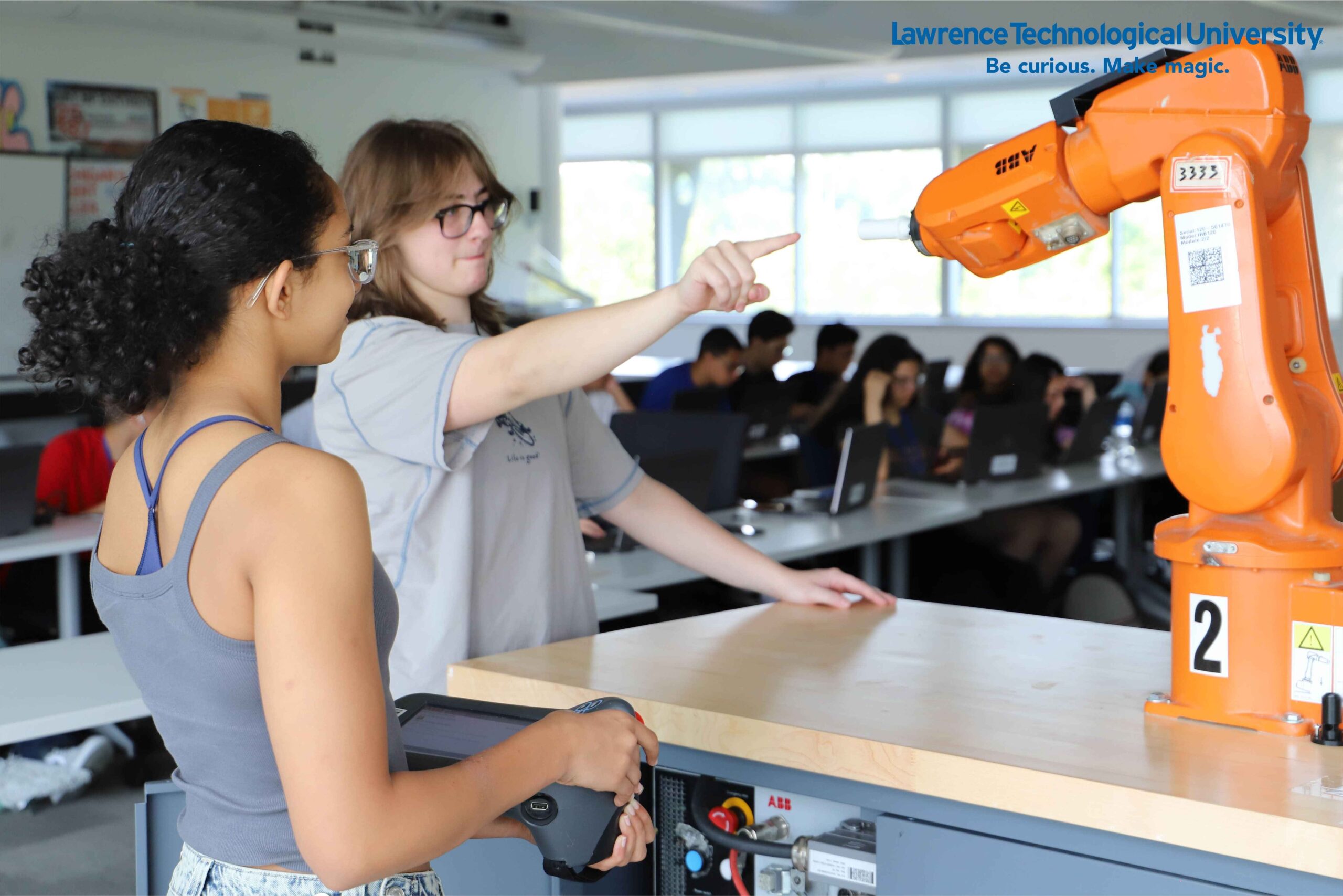 Students work with a robotics arm at Lawrence Technological University summer STEM programs in Southfield, gaining hands on engineering and tech experience