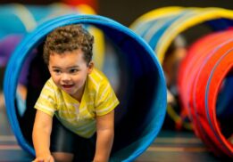 Mario Kart Live at Saline Recreation Center image of a child racing through an obstacle tunnel during active play.