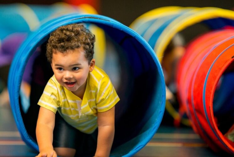 Mario Kart Live at Saline Recreation Center image of a child racing through an obstacle tunnel during active play.