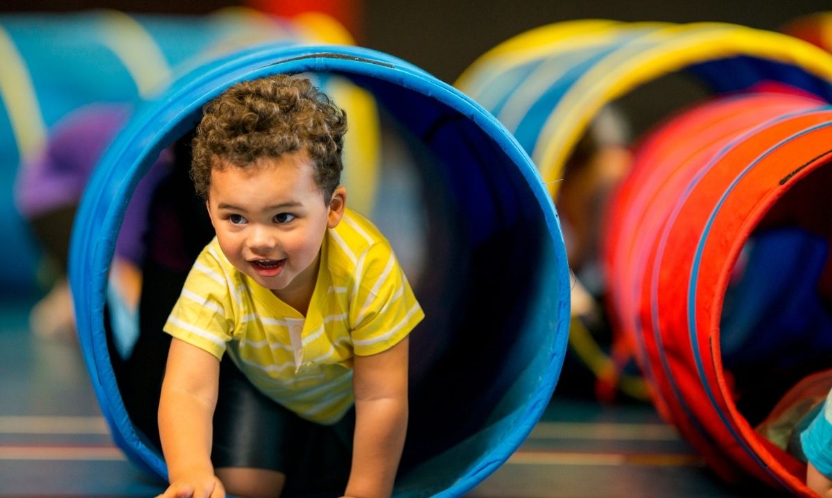 Mario Kart Live at Saline Recreation Center image of a child racing through an obstacle tunnel during active play.