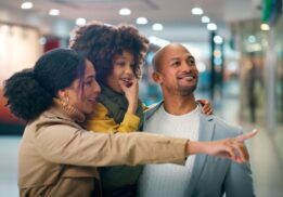 Family shopping together at mom 2 mom sale clarkston browsing kids clothing toys and baby gear at organized consignment event