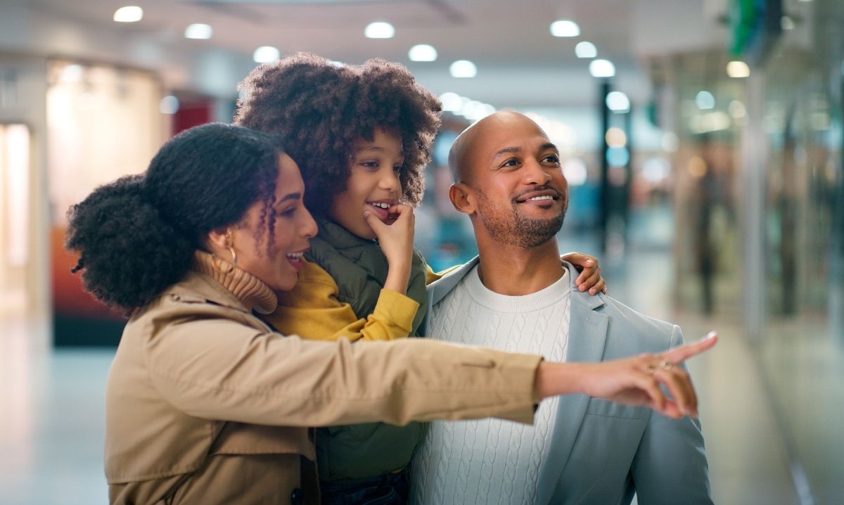 Family shopping together at mom 2 mom sale clarkston browsing kids clothing toys and baby gear at organized consignment event