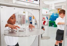Kids explore interactive sound displays during Sonic Sensation at Ann Arbor Hands-On Museum hands on STEM exhibit about sound waves and hearing
