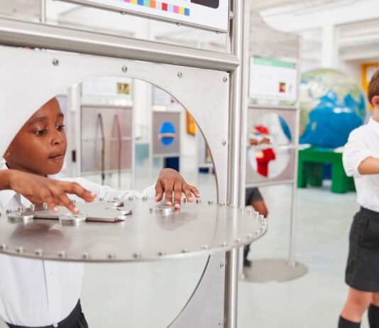 Sonic Sensation Exhibit at Ann Arbor Hands-On Museum Kids explore interactive sound displays during Sonic Sensation at Ann Arbor Hands-On Museum hands on STEM exhibit about sound waves and hearing