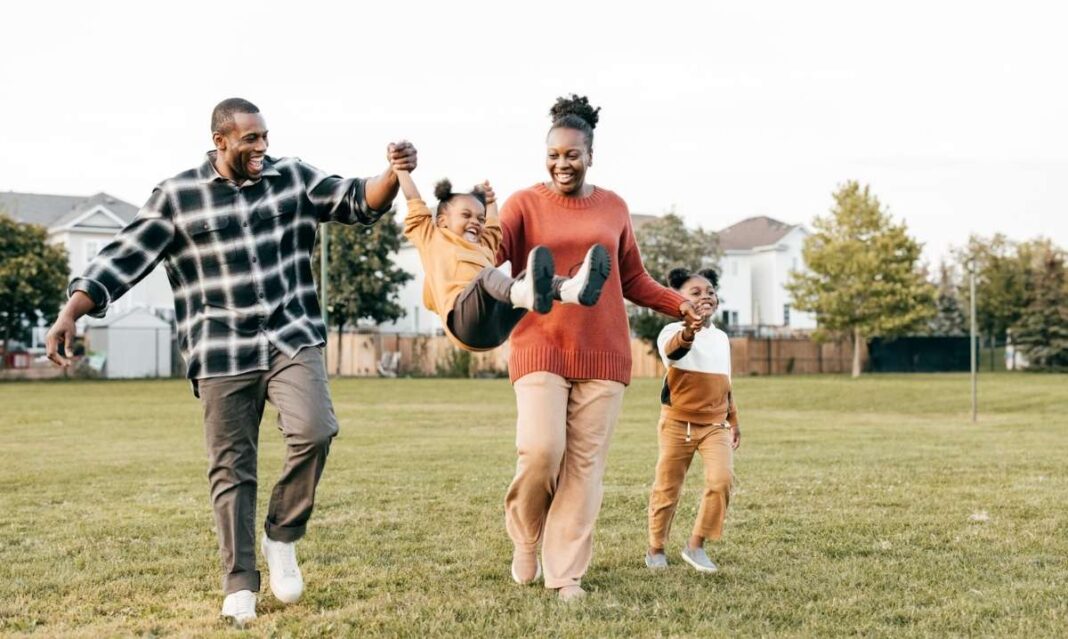 Family enjoying Spring Stroll at Downtown Birmingham with kids walking and playing together outdoors at a fun shopping event