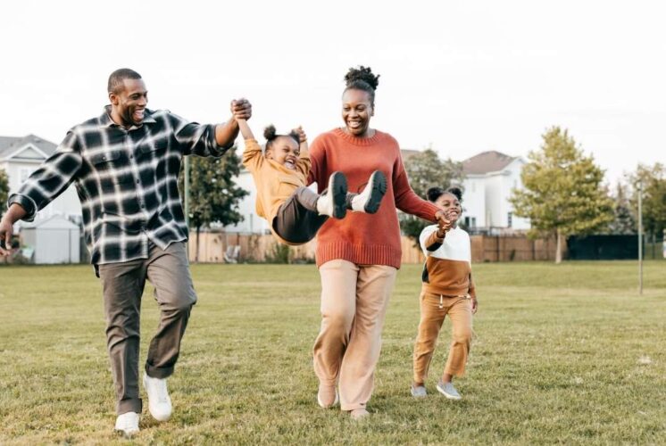 Family enjoying Spring Stroll at Downtown Birmingham with kids walking and playing together outdoors at a fun shopping event