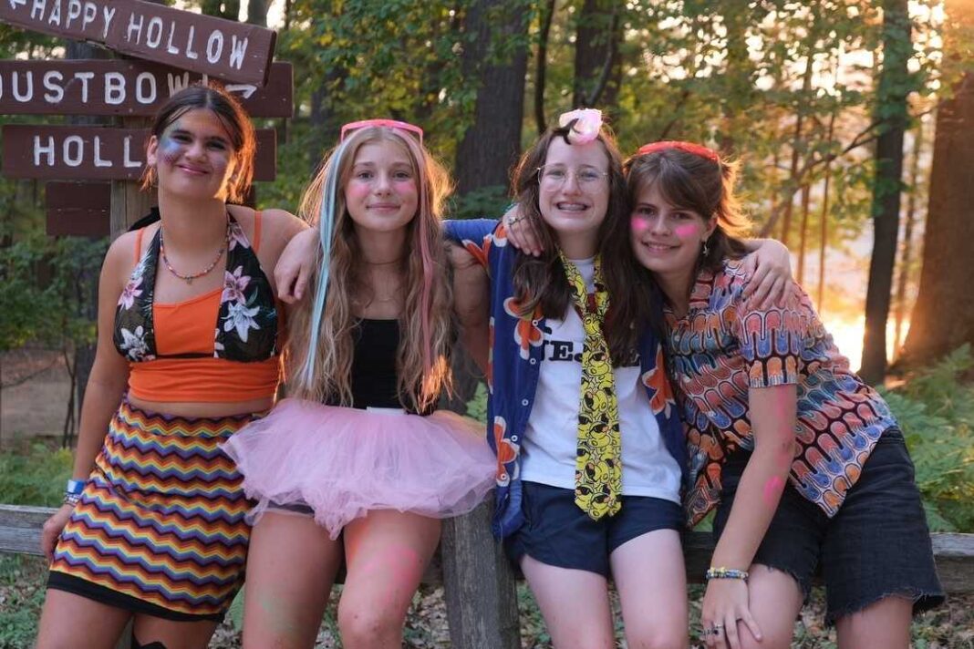 Girls at YMCA Camp Arbutus Hayo-Went-Ha pose with friends during evening program near Arbutus Lake in Traverse City Michigan