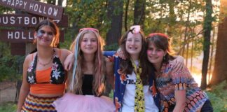 Girls at YMCA Camp Arbutus Hayo-Went-Ha pose with friends during evening program near Arbutus Lake in Traverse City Michigan