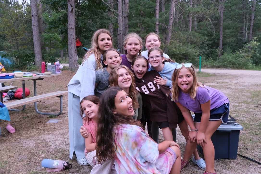 Girls at YMCA Camp Arbutus Hayo-Went-Ha gather with friends during cabin life building connection and confidence outdoors