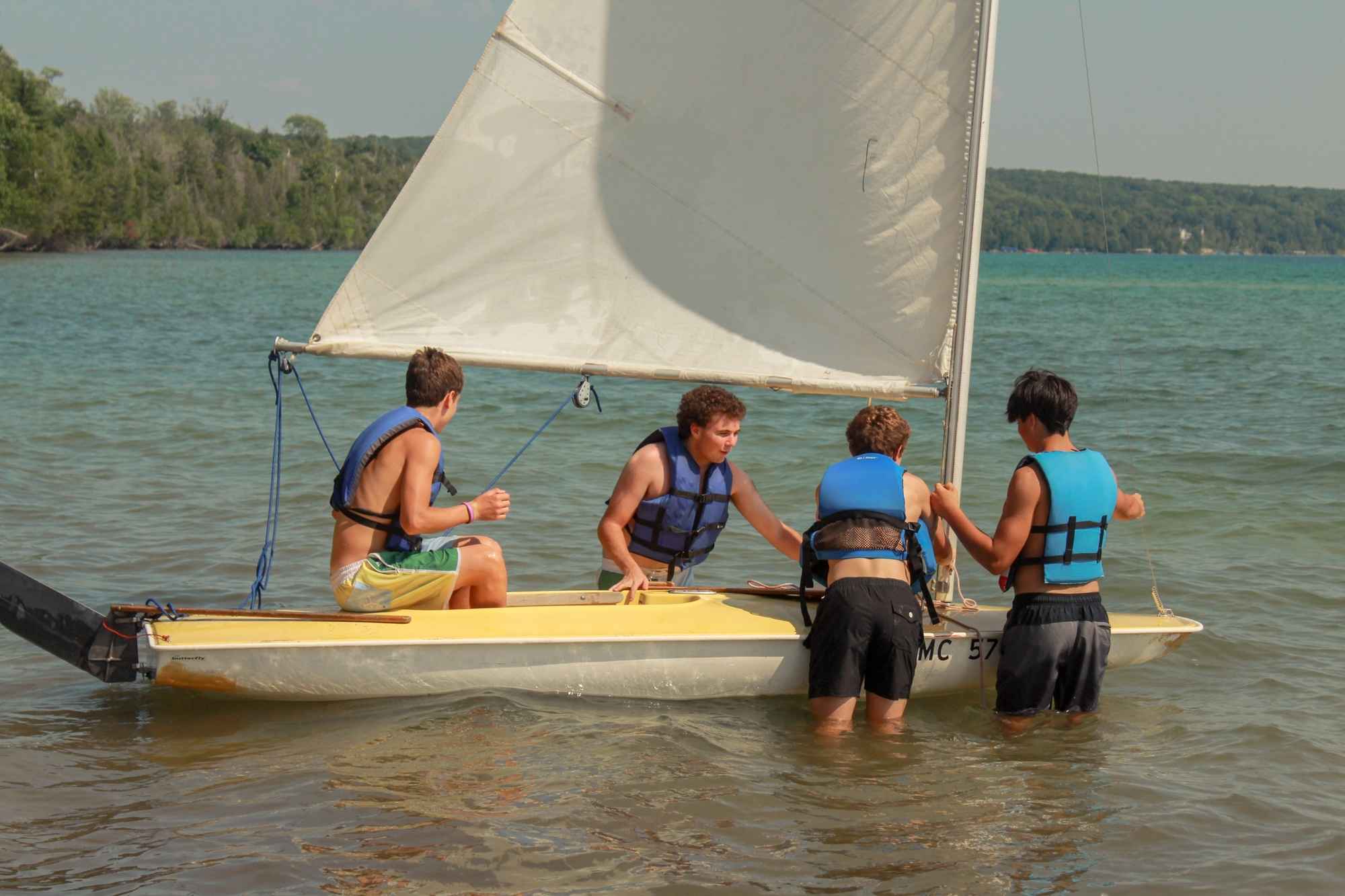 Campers learn sailing on Torch Lake at YMCA Camp Torch Hayo-Went-Ha in Central Lake Michigan, building skills and teamwork on the water